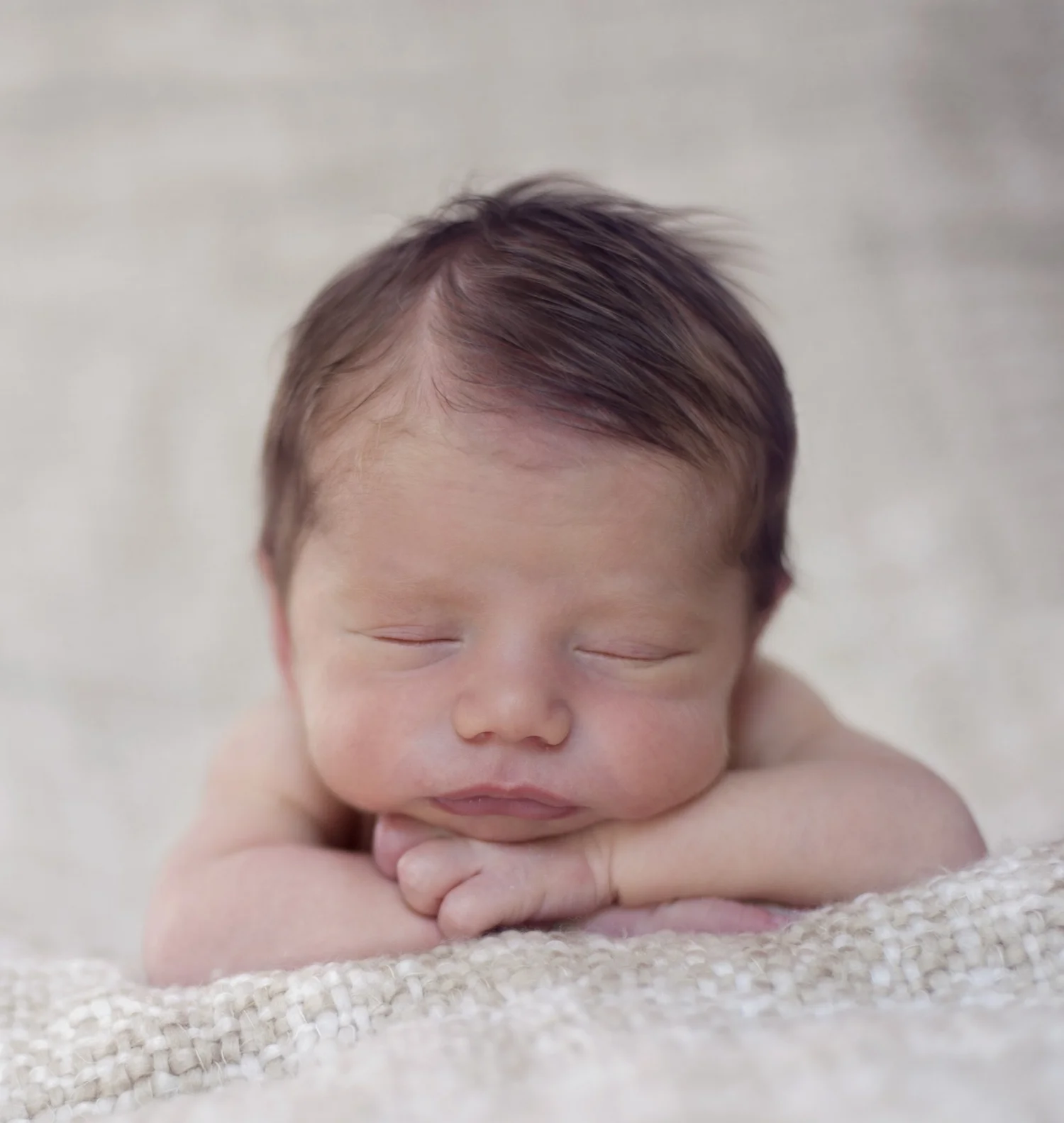 Parent gently holding a newborn baby